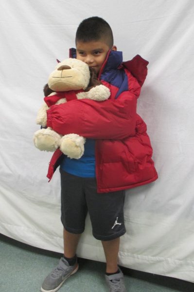 10 - Little boy with his new coat and stuffed animal